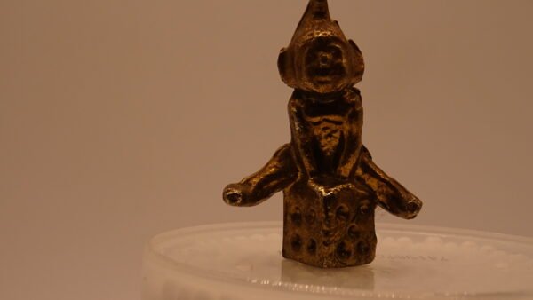 Brass Gnome sitting on a dice